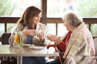 senior woman and caregiver sitting while talking
