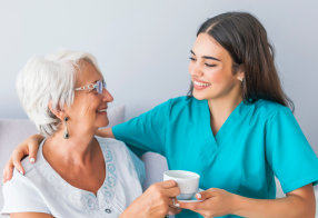 happy senior woman with her caregiver