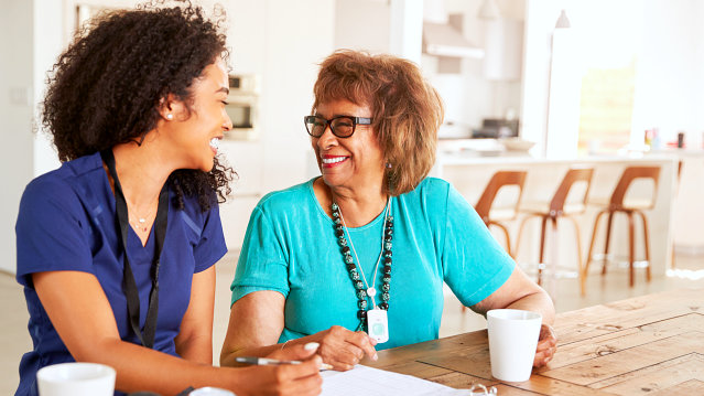 a happy elderly woman with her caregiver