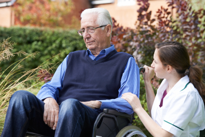 caregiver talking to a senior man