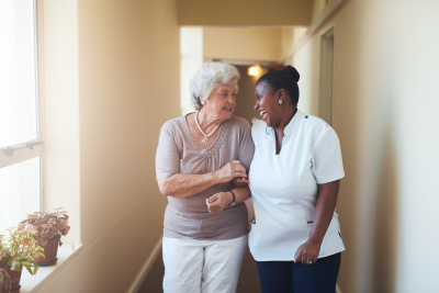 senior woman and woman walking together while talking