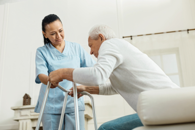 caregiver helping senior man