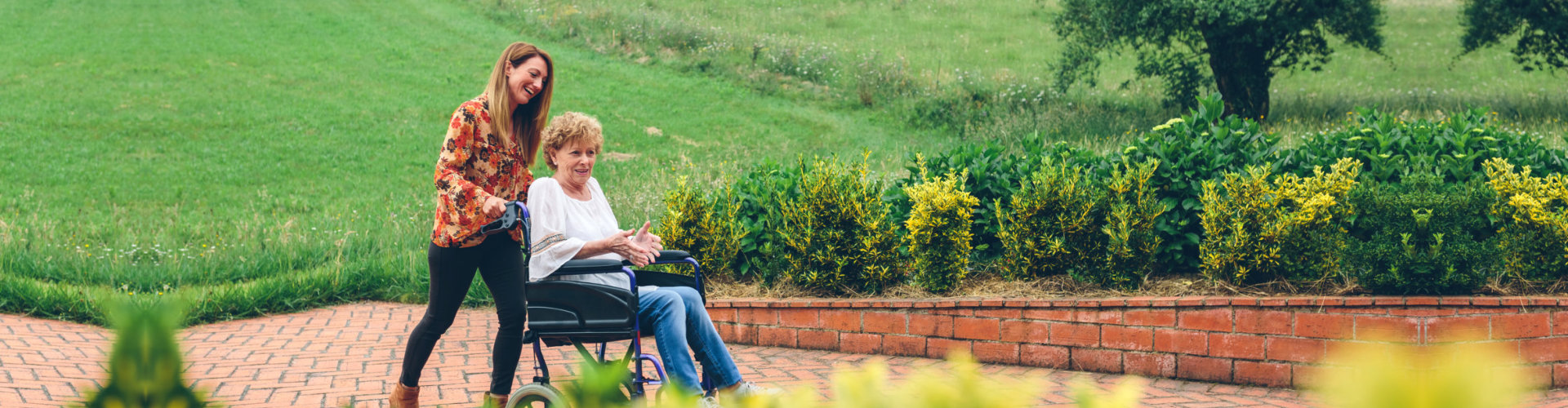 young woman and senior on a garden