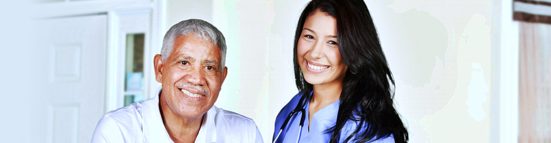 caregiver and senior man smiling